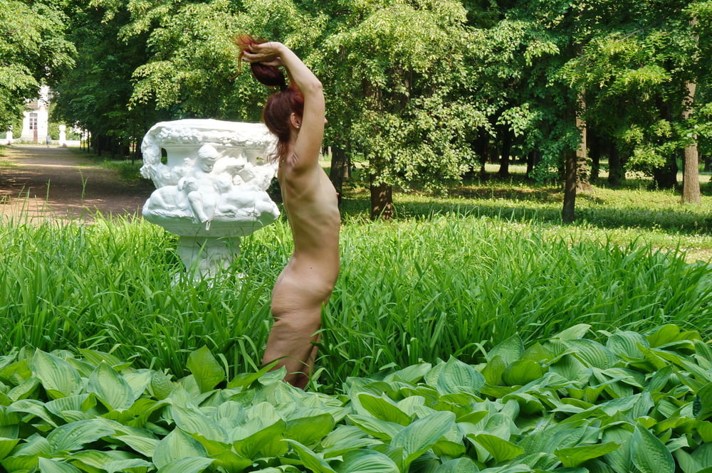 Naked in the grass by the vase #106992966