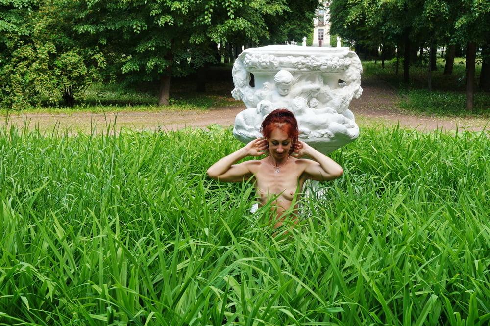 Naked in the grass by the vase #106993038