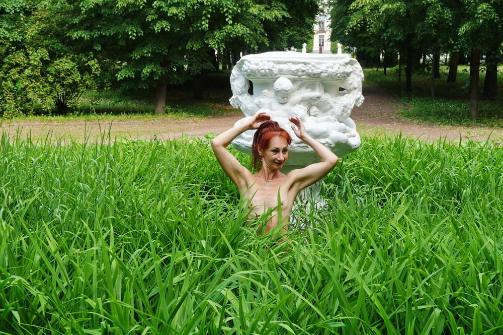 Naked in the grass by the vase #106993040