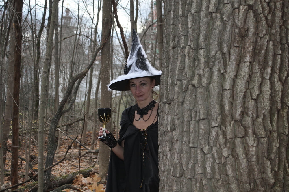 Witch with broom in forest #106868504