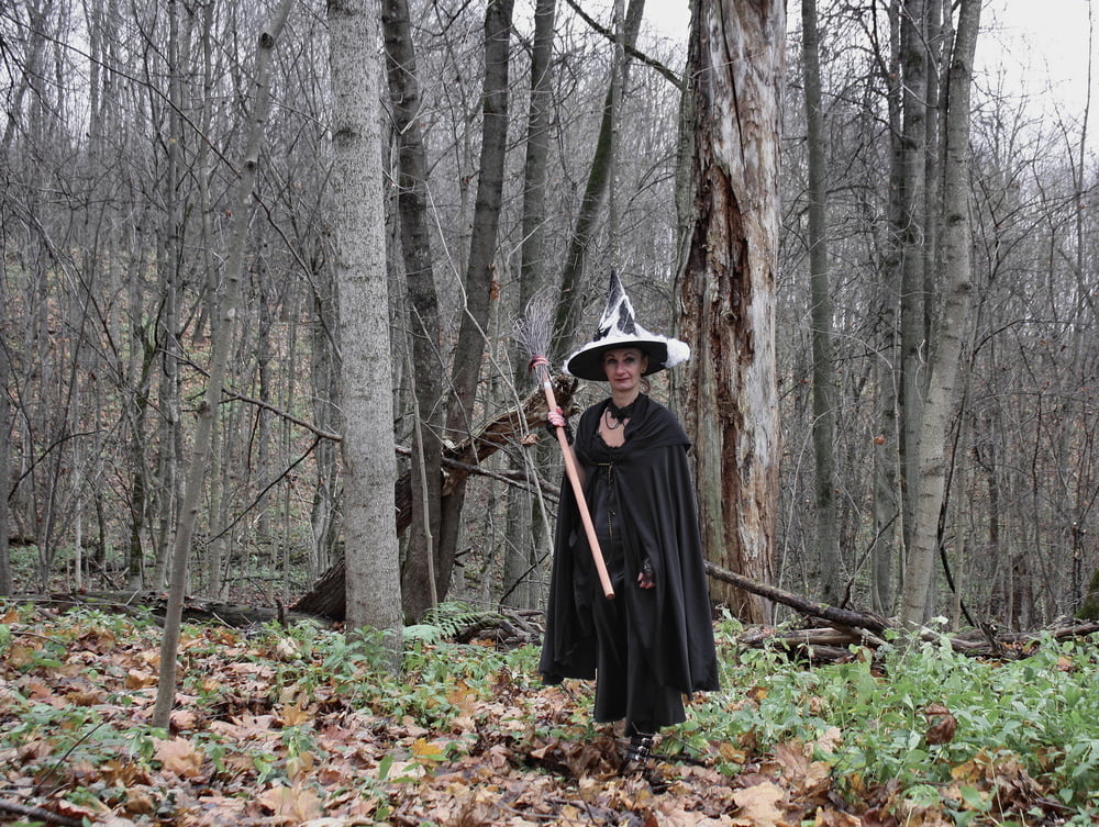 Witch with broom in forest #106868544