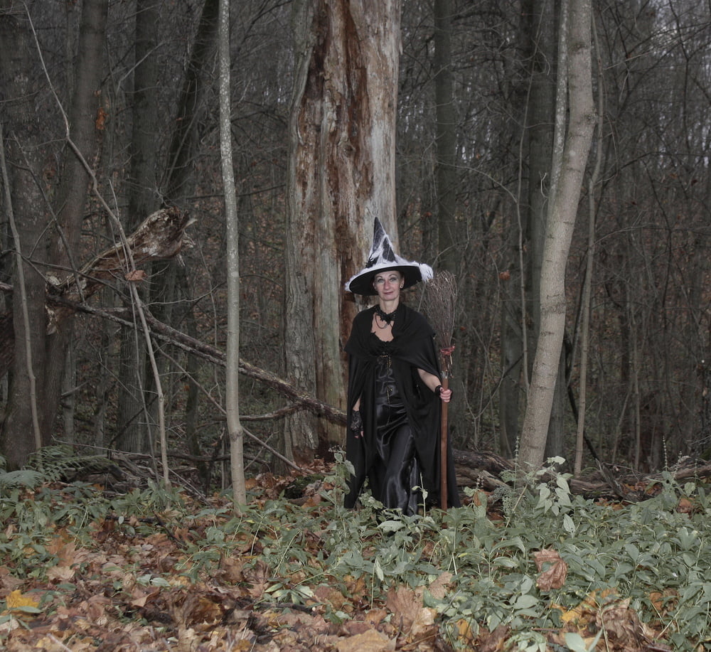 Witch with broom in forest #106868548