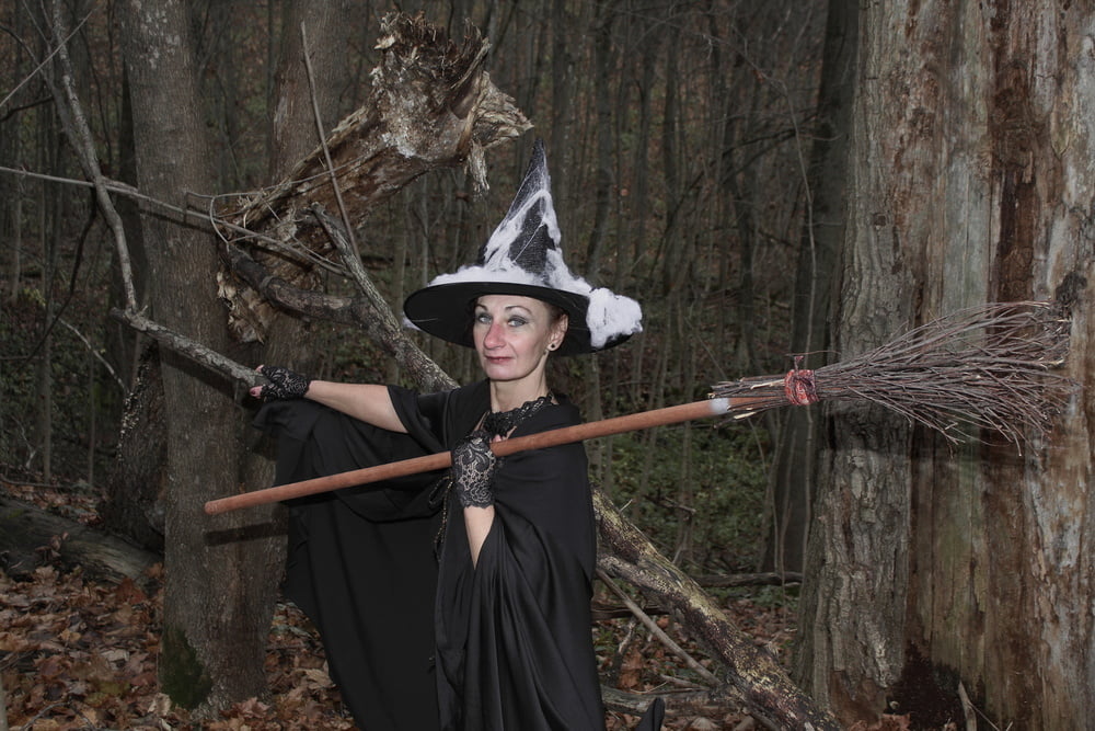 Witch with broom in forest #106868555