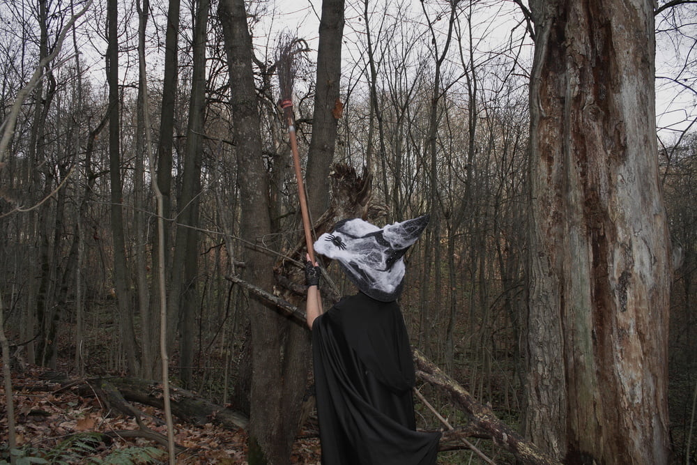 Witch with broom in forest #106868557