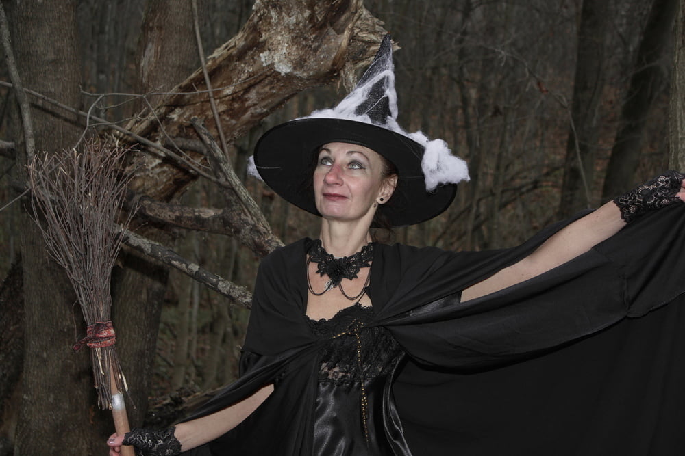 Witch with broom in forest #106868559