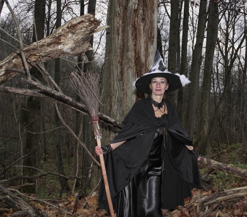 Witch with broom in forest #106868563