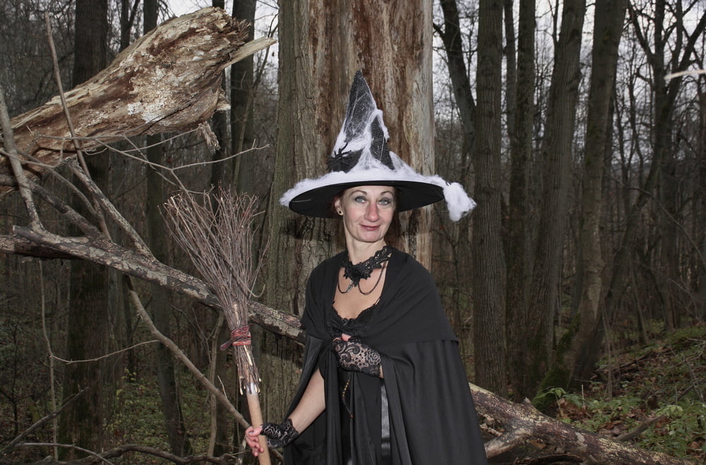 Witch with broom in forest #106868565