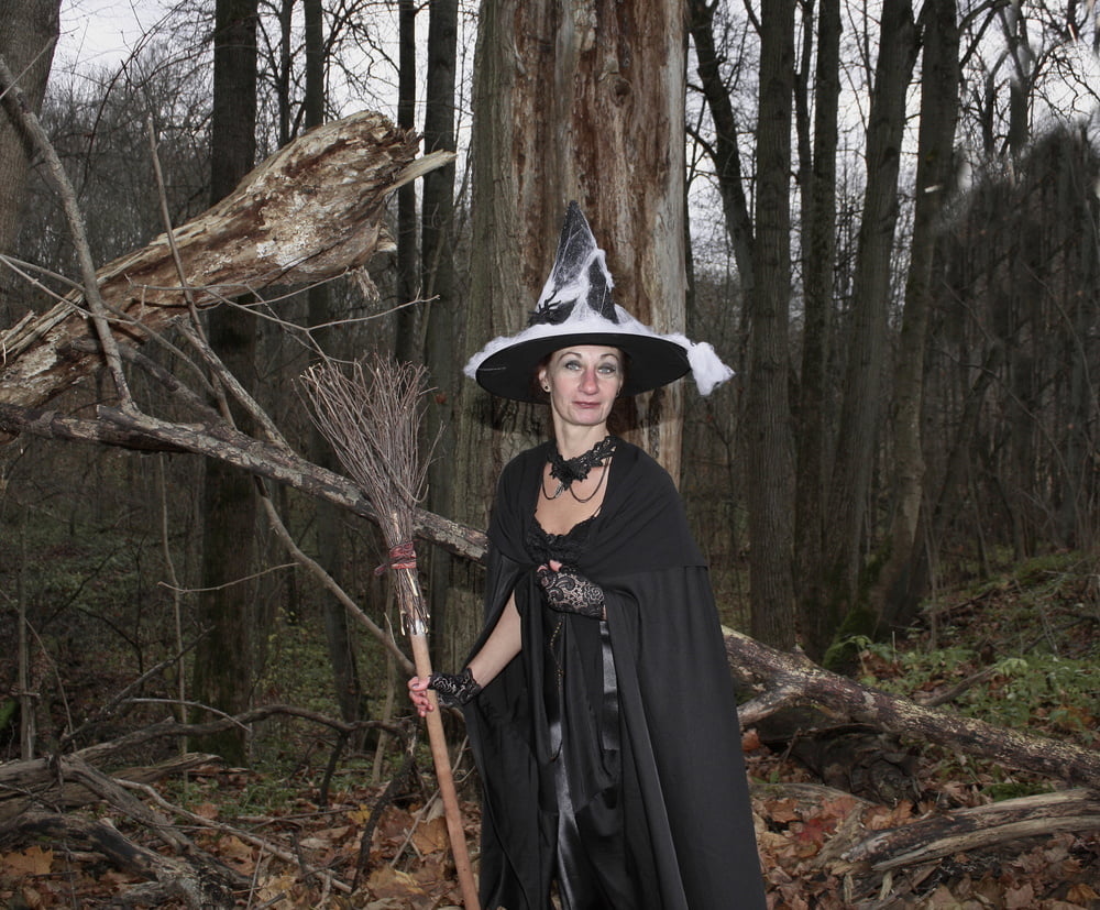 Witch with broom in forest #106868566