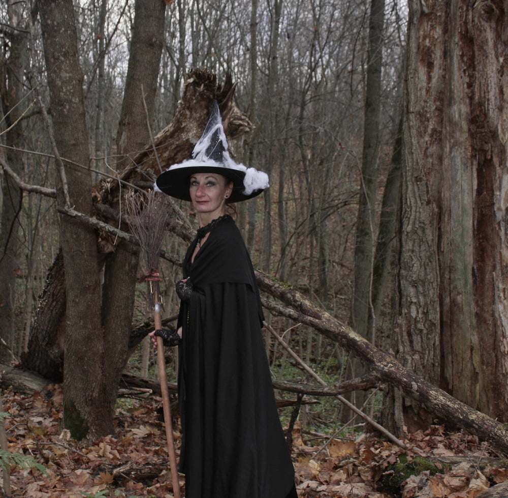 Witch with broom in forest #106868568