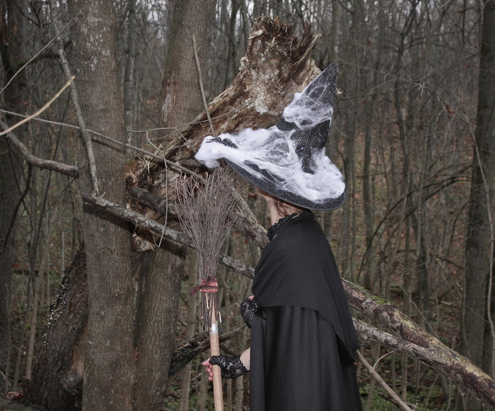 Witch with broom in forest #106868571