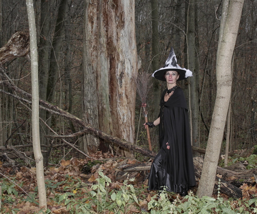 Witch with broom in forest #106868573