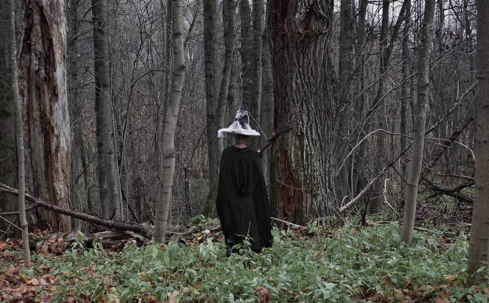 Witch with broom in forest #106868575