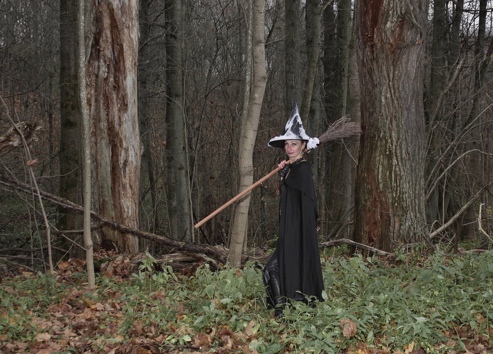 Witch with broom in forest #106868578