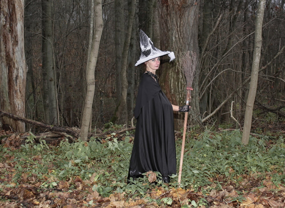 Witch with broom in forest #106868581