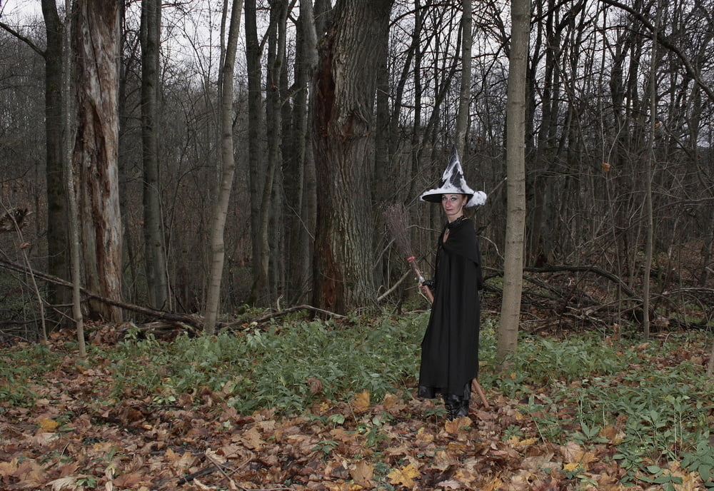 Witch with broom in forest #106868584