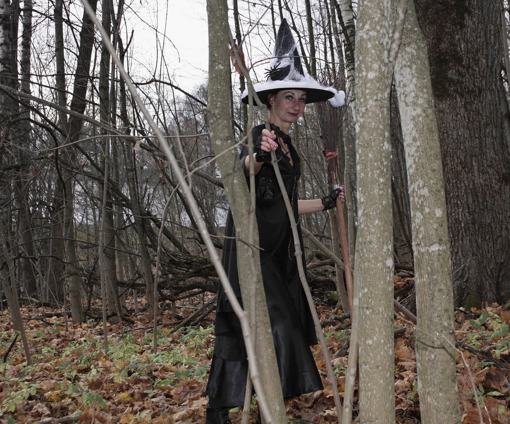 Witch with broom in forest #106868587