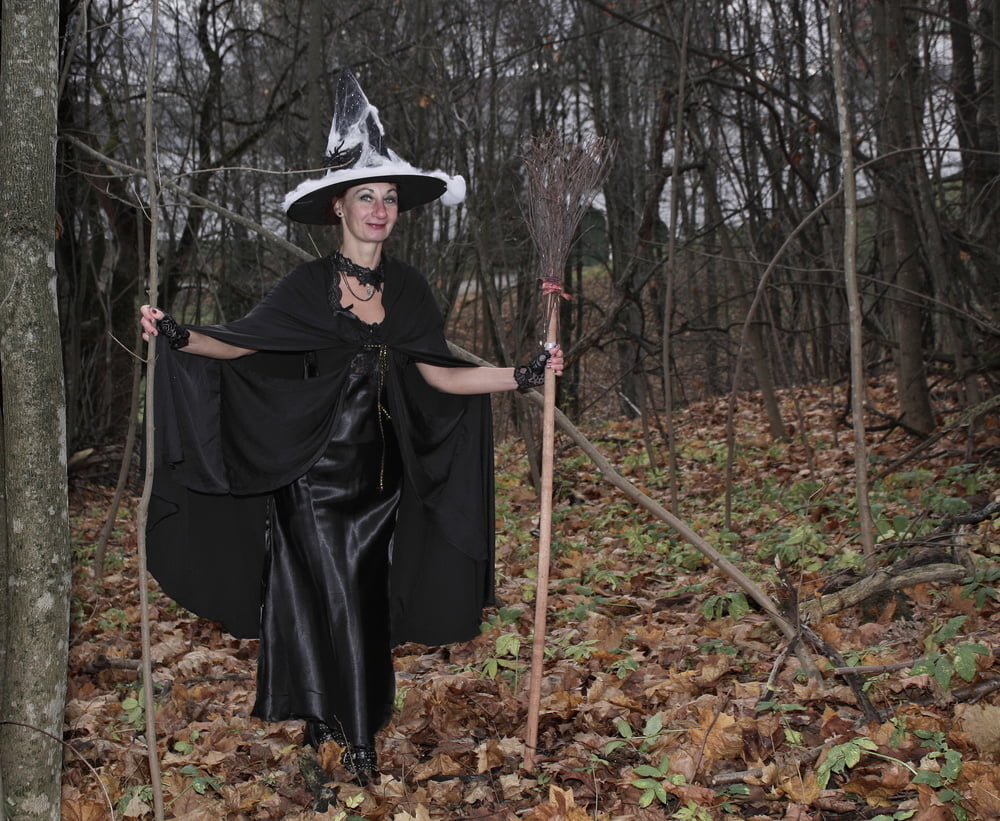 Witch with broom in forest #106868589