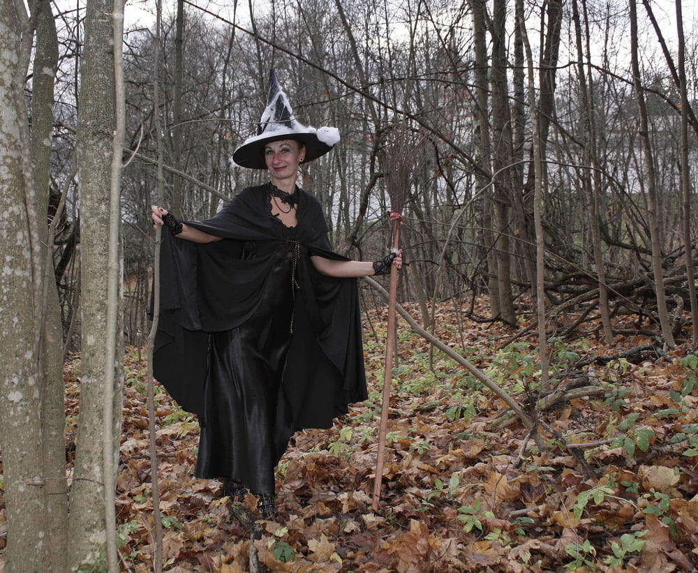 Witch with broom in forest #106868591