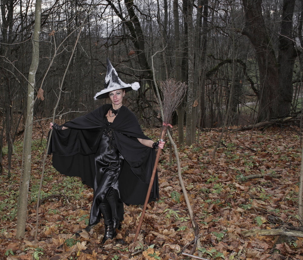 Witch with broom in forest #106868593