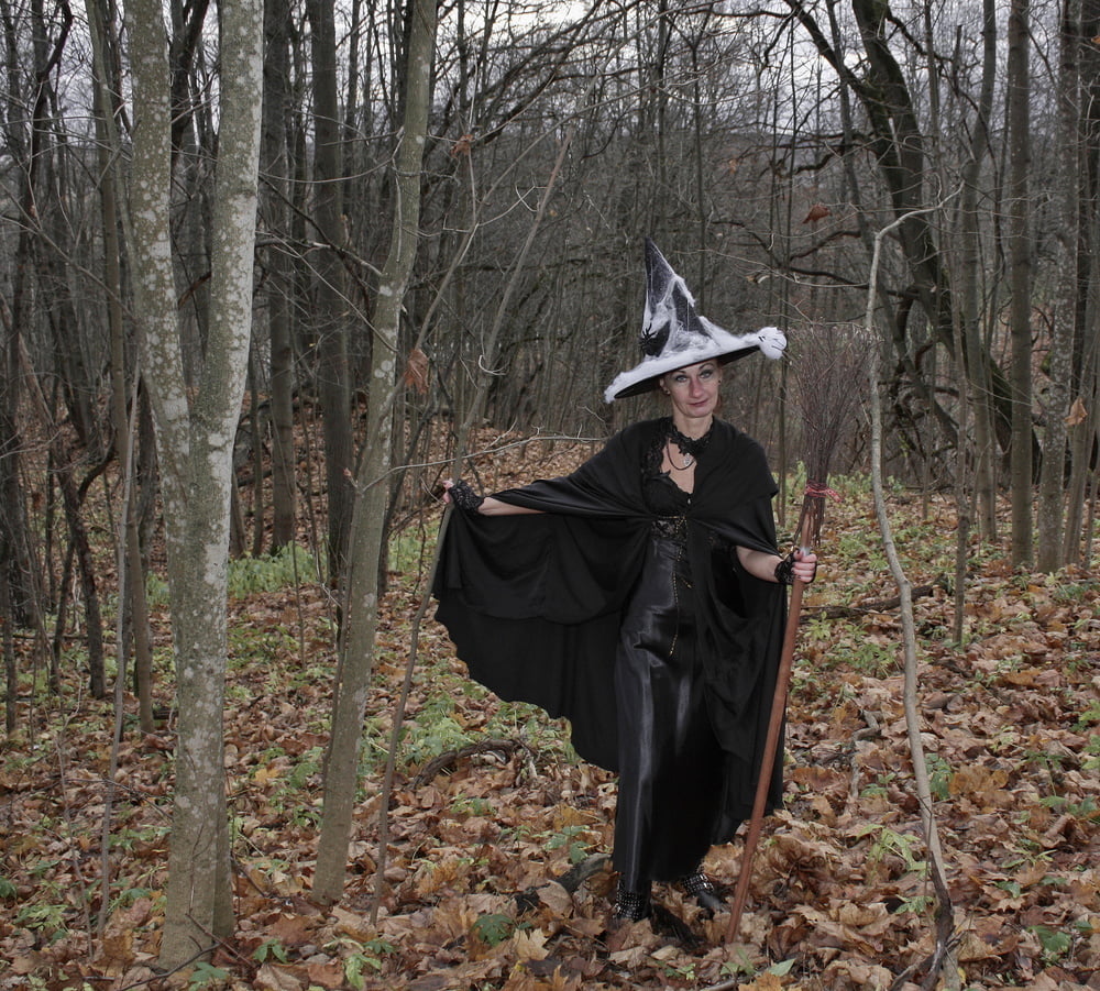 Witch with broom in forest #106868595