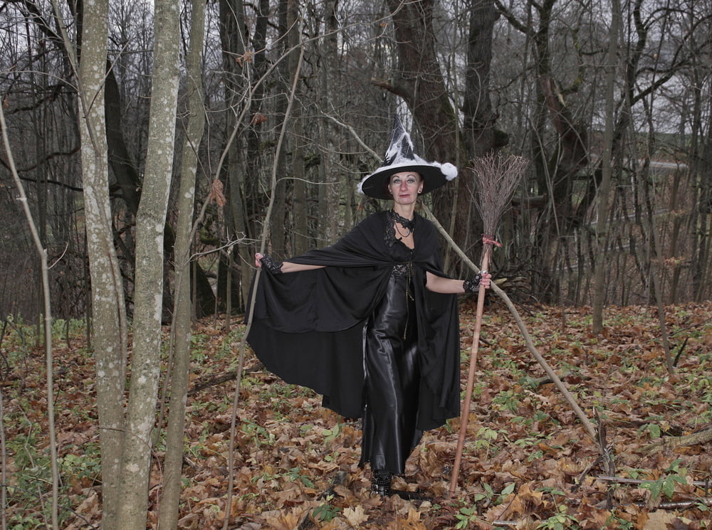 Witch with broom in forest #106868596