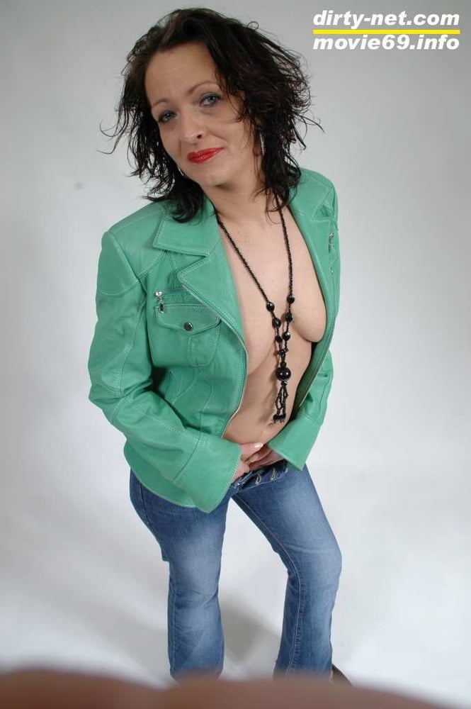 MILF Lea is making up her lips in a green leather jacket #106687504