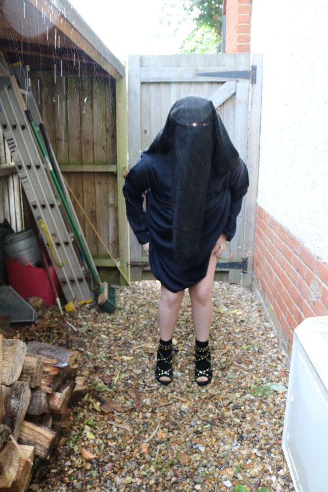 Burqa Outdoors Flashing in the Rain #106932232