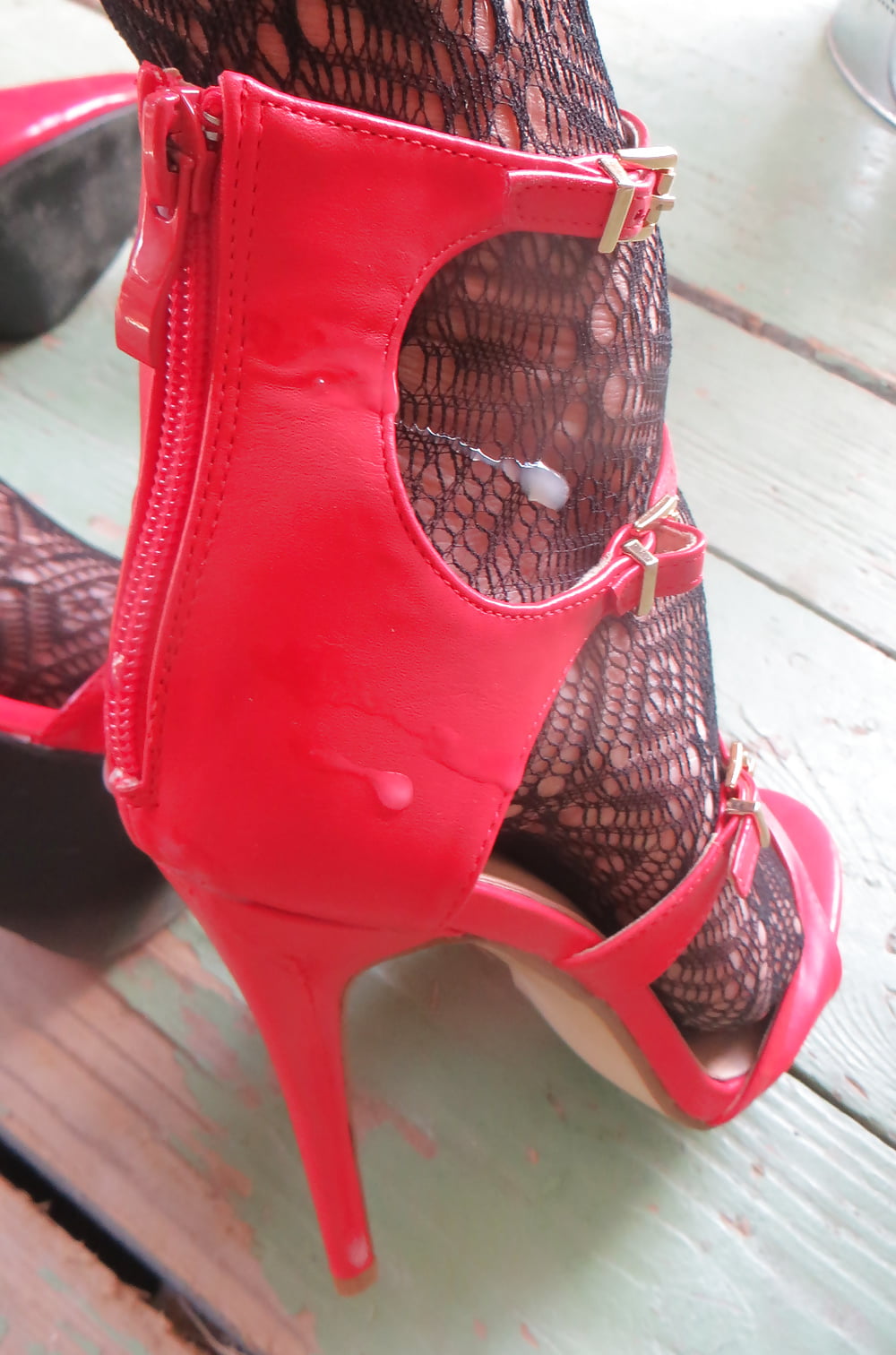 cummed red zipper of her ankle strap heels #106964813
