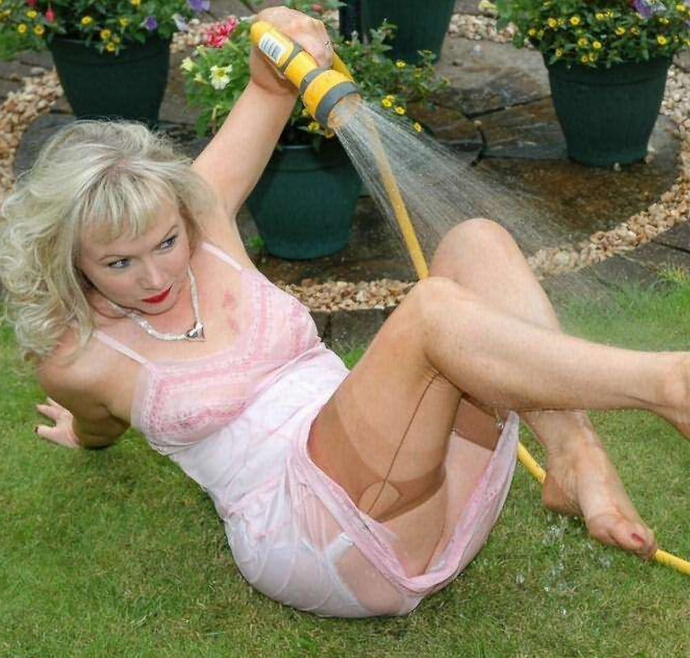 Sue wets her slip in the garden #103667420
