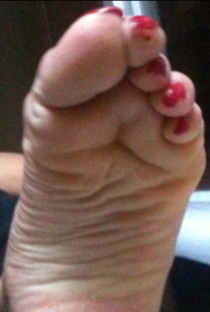 used red toenails, and soles feet after day at beach #106839555