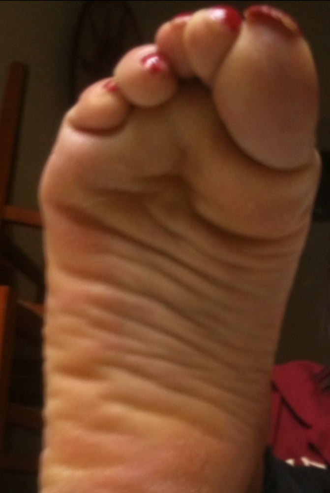 used red toenails, and soles feet after day at beach #106839571