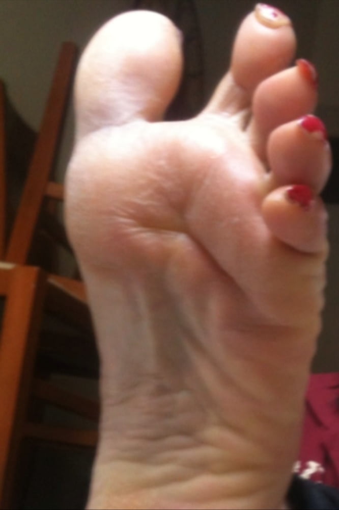 used red toenails, and soles feet after day at beach #106839579