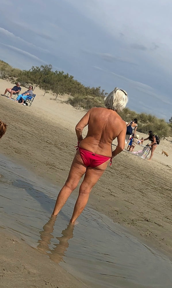 Granny topless at the beach #93539682