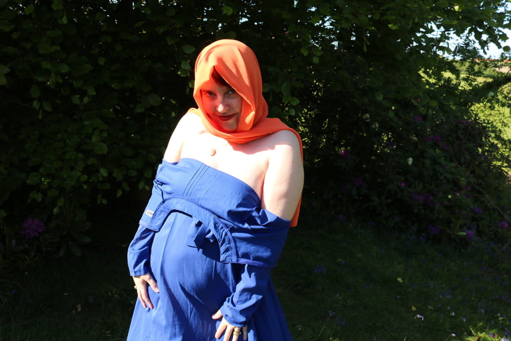 hijab and abaya flashing outdoors #106961742