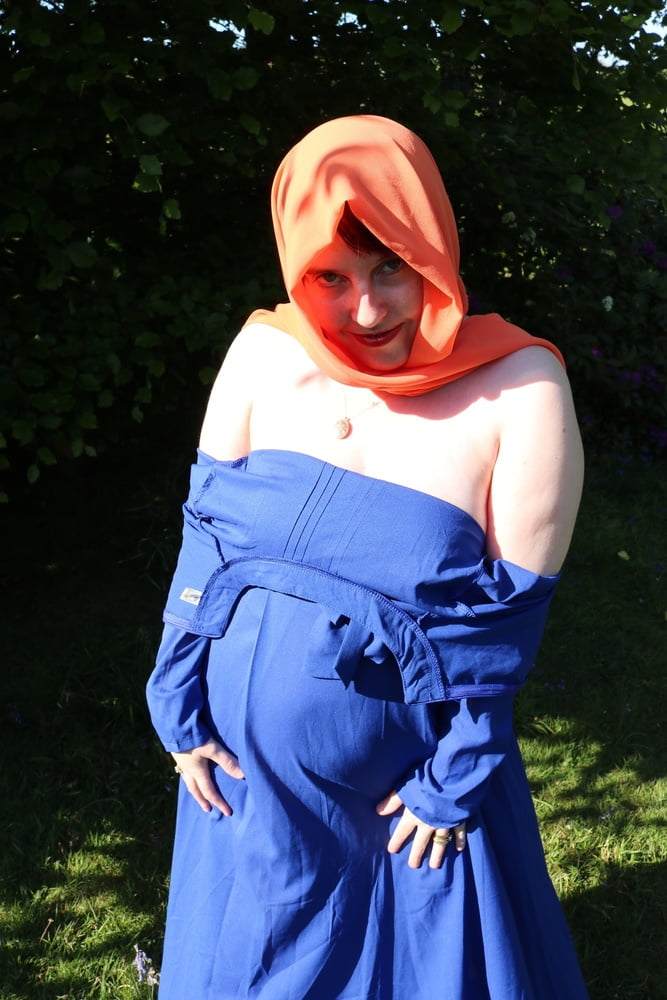 hijab and abaya flashing outdoors #106961743