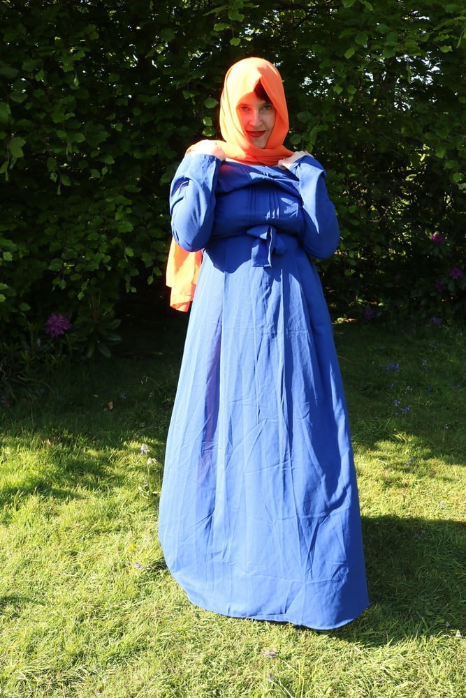 hijab and abaya flashing outdoors #106961749