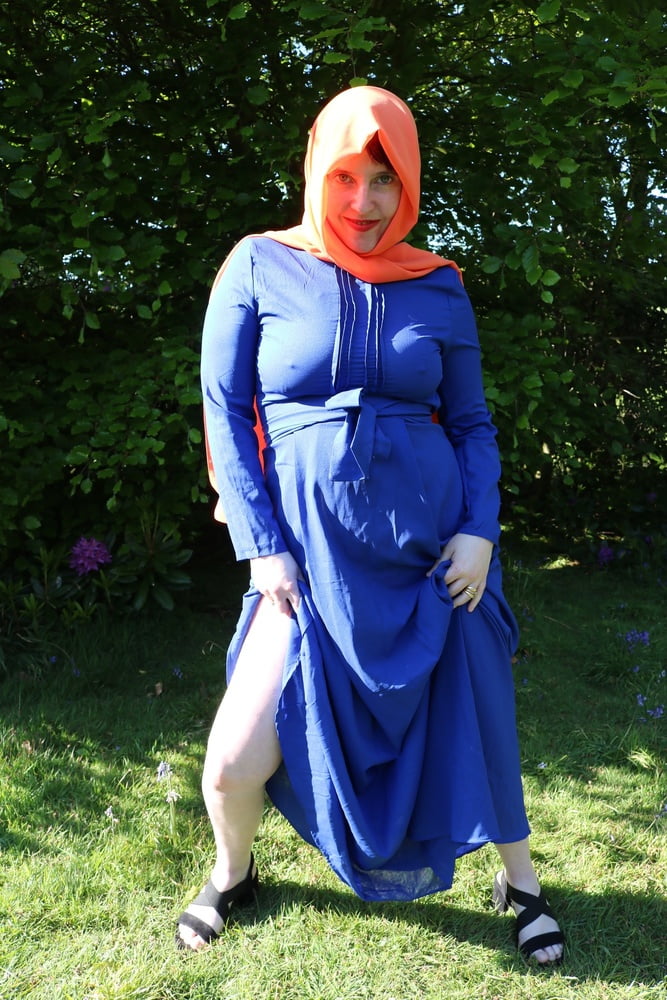 hijab and abaya flashing outdoors #106961764