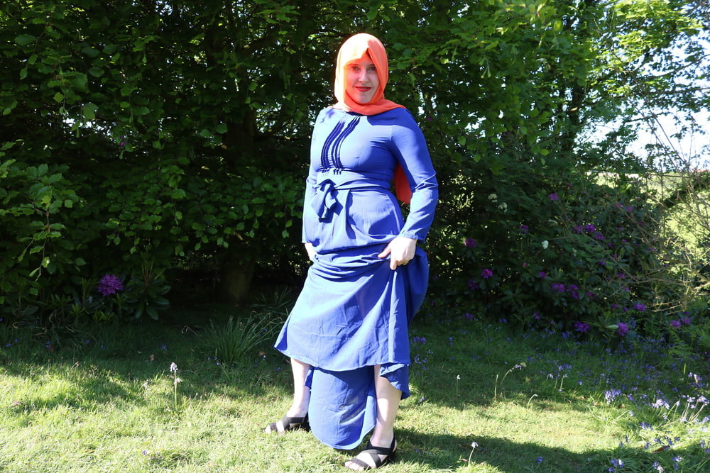 hijab and abaya flashing outdoors #106961765