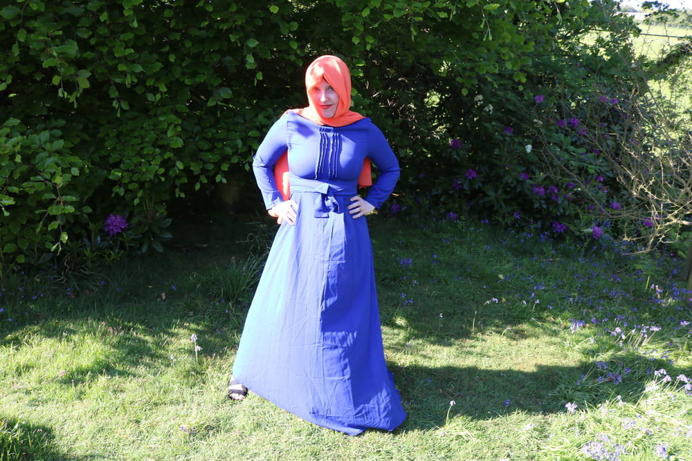 hijab and abaya flashing outdoors #106961770