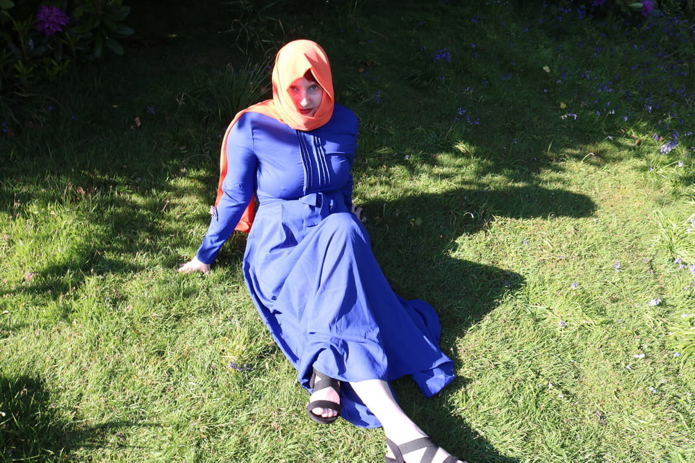 hijab and abaya flashing outdoors #106961776
