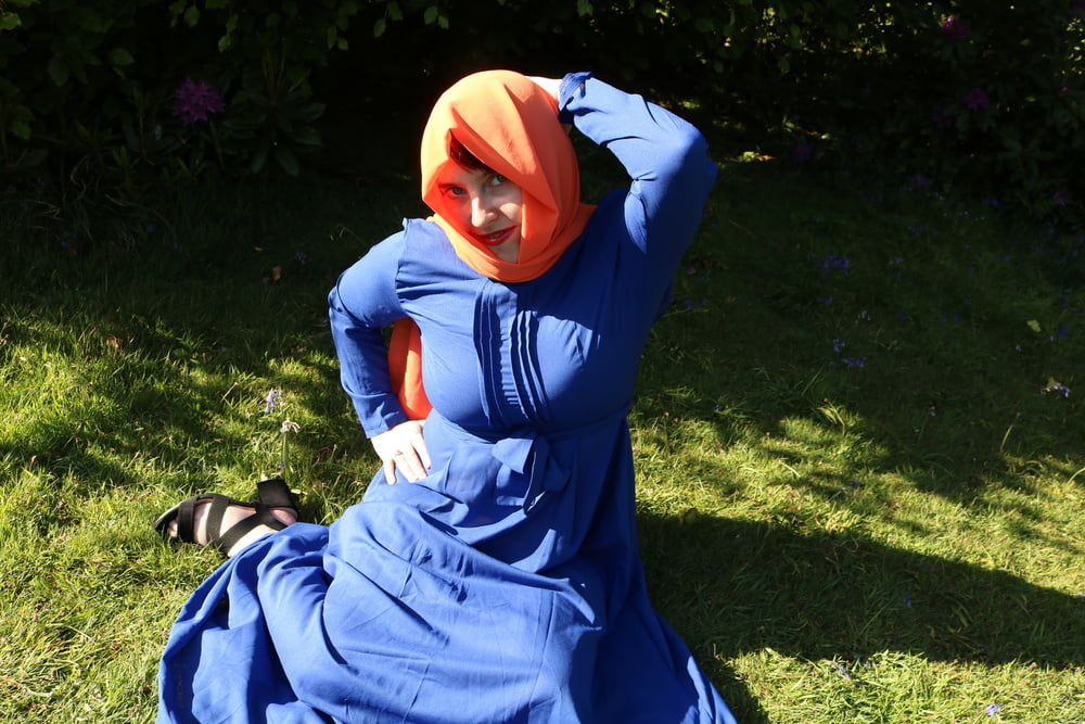 hijab and abaya flashing outdoors #106961779