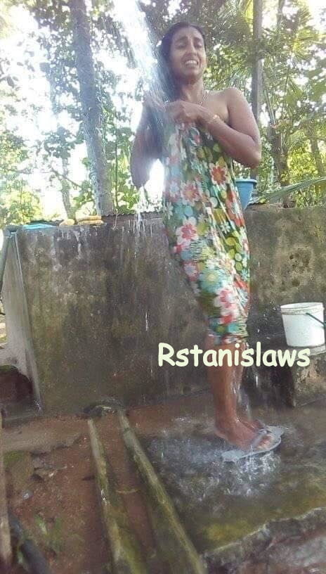 Sri lankan girls bathing outdoor
 #80867270