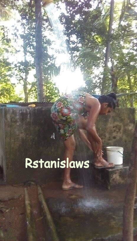 Sri lankan girls bathing outdoor
 #80867282