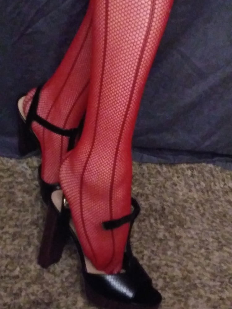 red fishnets and black heels #106710602