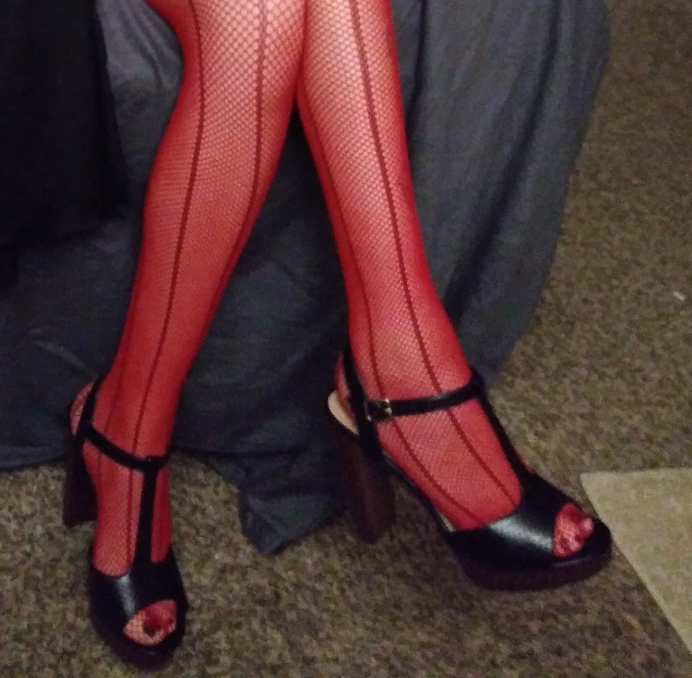 red fishnets and black heels #106710604