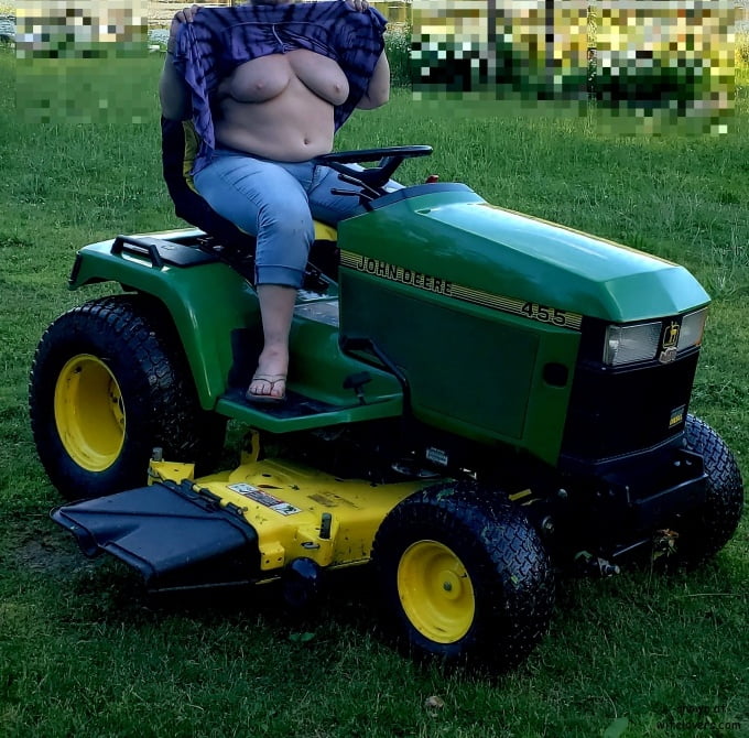Neighbor lady mowing her lawn today #98430027