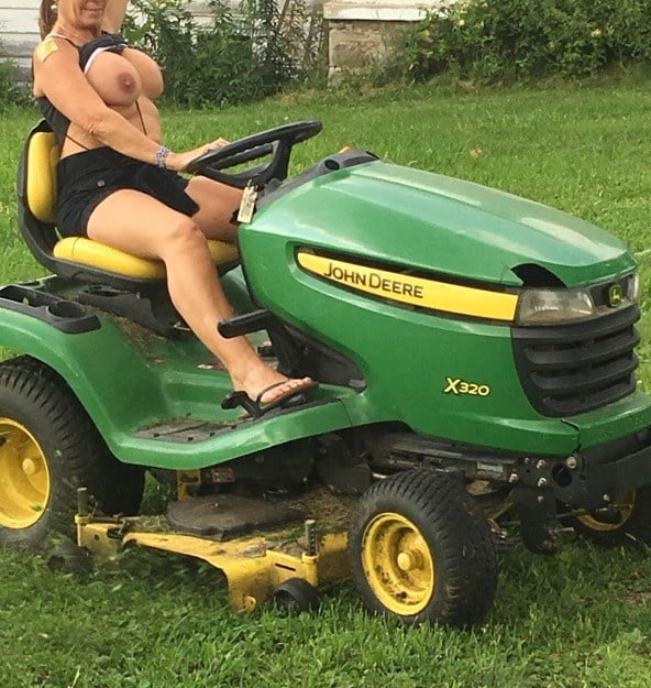 Neighbor lady mowing her lawn today #98430033