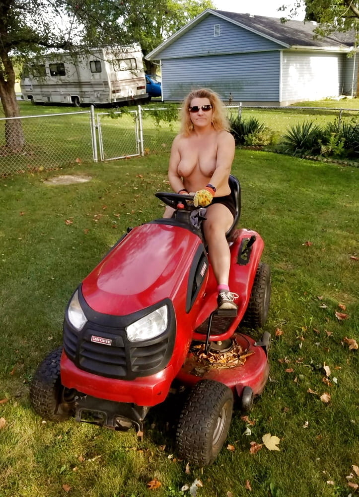 Neighbor lady mowing her lawn today #98430051