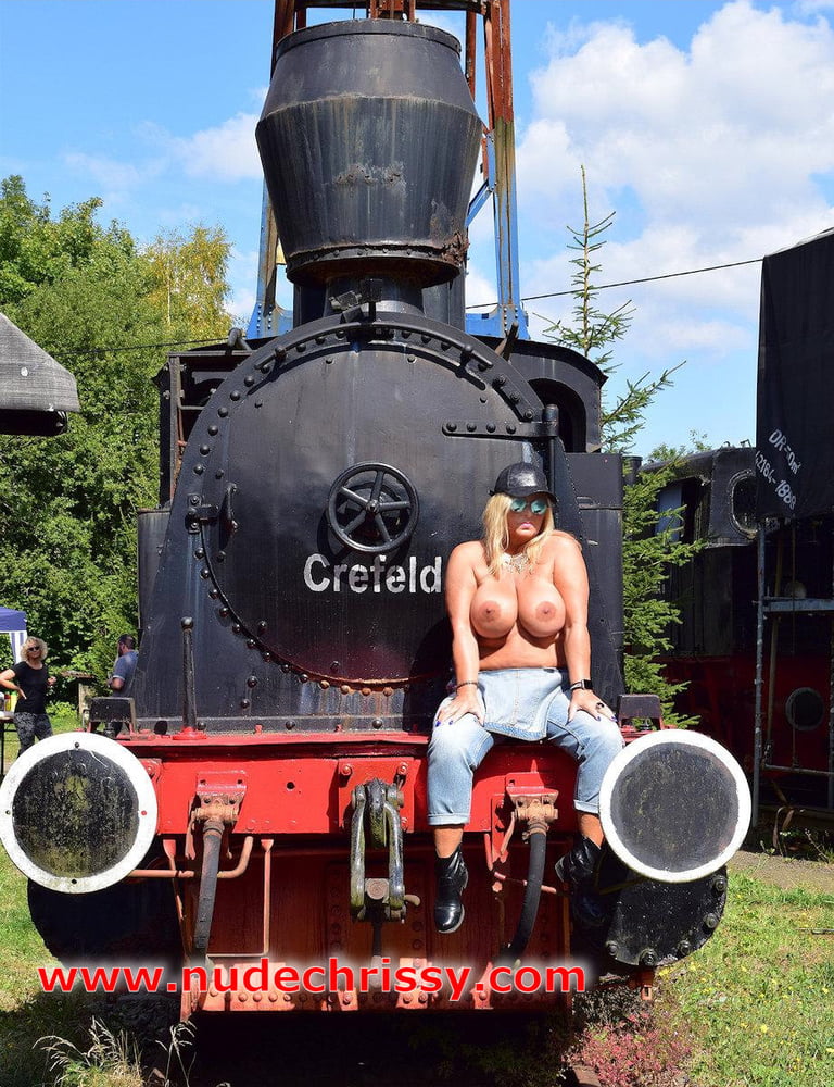 Naked between old locomotives #107166982